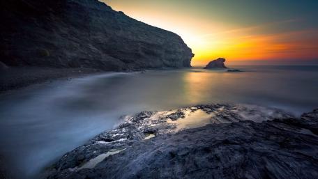 Serene Shoreline Under Afterglow Sky wallpaper