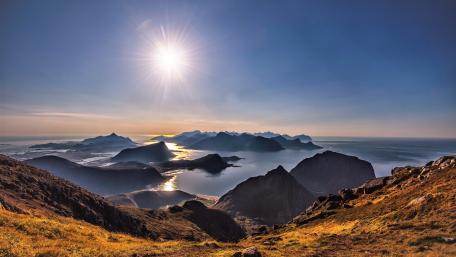Breathtaking Mountain Panorama Under Radiant Sunlight wallpaper