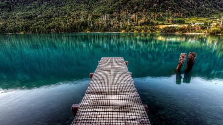 Tranquil Pier Over Serene Lake Water wallpaper