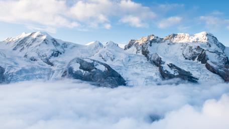Majestic Mountain Peaks Above a Sea of Clouds wallpaper
