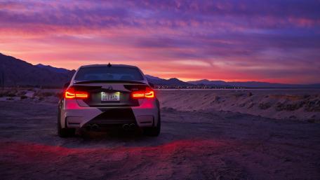 Vibrant Sunset with a Stunning Sports Car Backdrop wallpaper