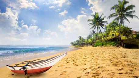 Peaceful Tropical Beach with Boat and Palm Trees wallpaper