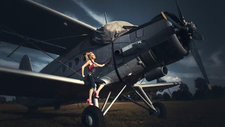 Aviation Dream: Woman and Aircraft in Flight Scene wallpaper