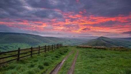 Majestic Sunset Over Rolling Hills and Valleys wallpaper