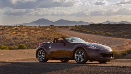 Sleek Convertible in Desert Landscape wallpaper