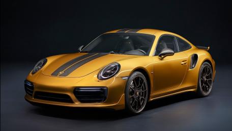 Stylish Gold Porsche Turbo in Spotlight wallpaper