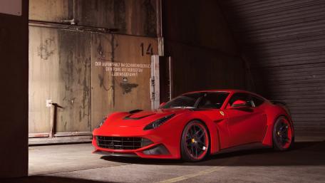 Bold Red Ferrari in Industrial Setting wallpaper