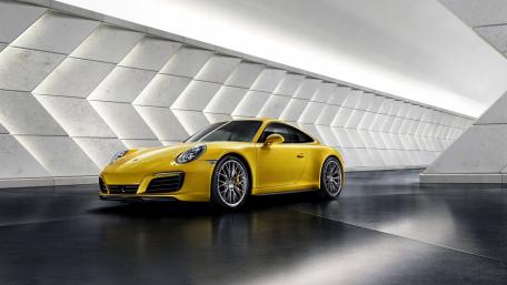 Sleek Yellow Sports Car in a Modern Setting wallpaper