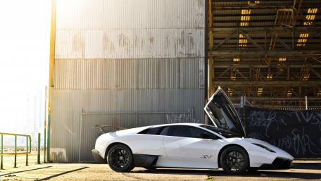 Sleek White Supercar in Urban Setting wallpaper