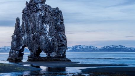 Majestic Rocky Formation by Calm Waters wallpaper