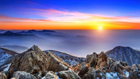 Majestic Mountain Sunrise Over Serene Valleys wallpaper