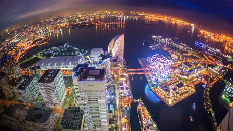 Vibrant Nightscape of a City by the Water wallpaper