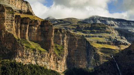 Majestic Mountain Landscape with Lush Greenery and Waterfall wallpaper