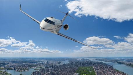 Sleek Aircraft Soaring Above the Cityscape wallpaper