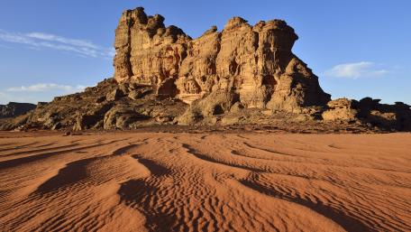 Majestic Desert Landscape with Towering Rock Formation wallpaper