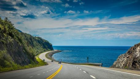 Scenic Coastal Road Beneath a Clear Blue Sky wallpaper