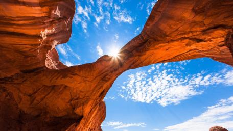 Majestic Arch Beneath Vast Blue Sky wallpaper