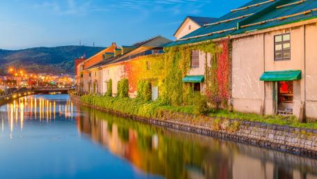 Charming Cityscape at Dusk Over Tranquil Waters wallpaper