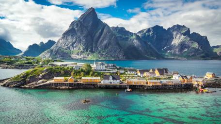 Stunning Coastal Village with Majestic Mountains and Clear Waters wallpaper