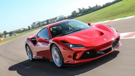 Sleek Red Performance Car on Track wallpaper