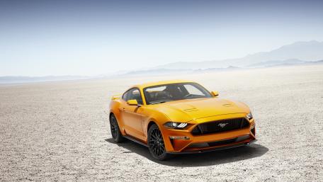Bold Orange Mustang in a Desert Landscape wallpaper