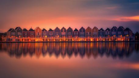 Vibrant Reflections of Colorful Houses by the Water wallpaper