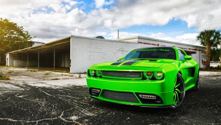 Vibrant Green Muscle Car in Urban Setting wallpaper