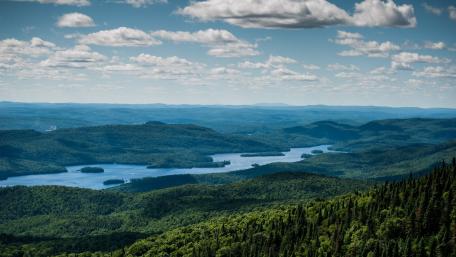 Breathtaking Vista of Lush Green Mountains and Serene Lakes wallpaper