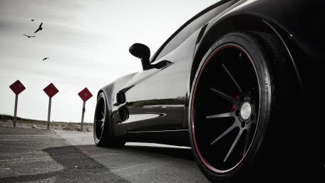 Sleek Black Sports Car on the Road wallpaper