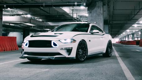 Sleek White Mustang in an Urban Garage Setting wallpaper
