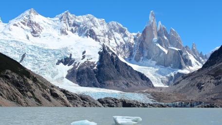 Majestic Snow-Capped Mountains Above Crystal Clear Waters wallpaper