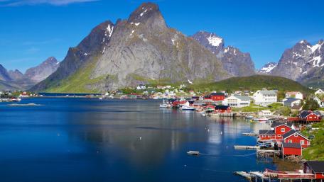 Breathtaking Fjord Landscape with Majestic Mountains and Vibrant Houses wallpaper