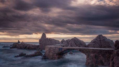 Majestic Rocky Coastline Under Dramatic Skies wallpaper