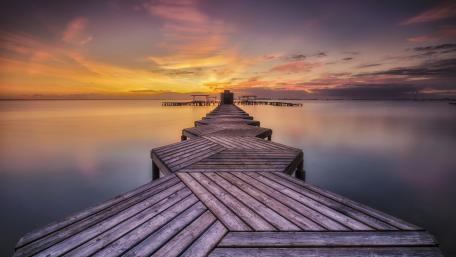 Serene Sunset Over Tranquil Pier wallpaper