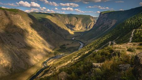 Breathtaking Valley Scenery with Serene River Flowing Through Nature's Wonder wallpaper