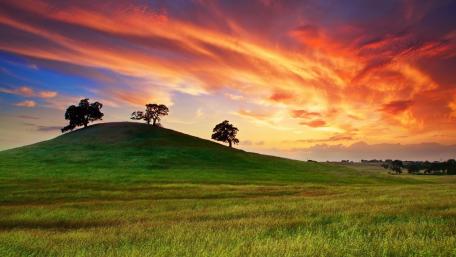 Serene Sunset Over Rolling Hills wallpaper