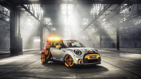 Dynamic Mini Cooper Electric Car in a Dramatic Setting wallpaper
