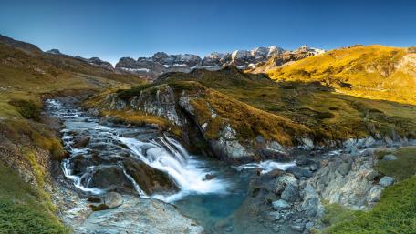 Breathtaking Mountain Landscape with Flowing Waterfall wallpaper