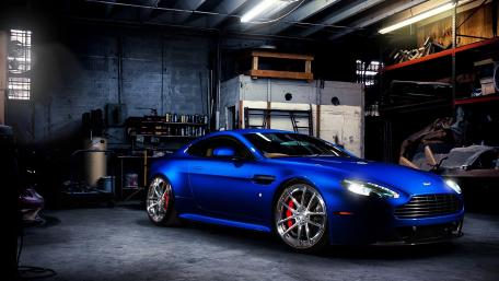 Sleek Blue Car in a Garage Setting wallpaper