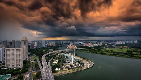 Majestic Singapore Skyline Under Dramatic Clouds wallpaper