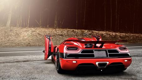 Sleek Red Sports Car on Open Road wallpaper