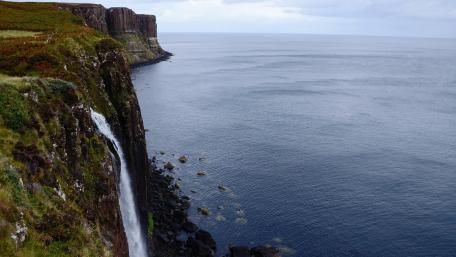 Majestic Waterfall by the Cliffside Sea wallpaper
