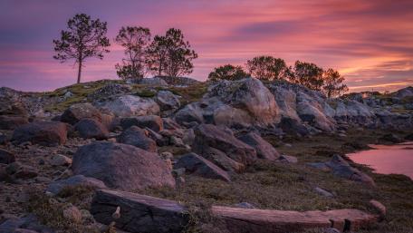 Serene Sunset Over Rocky Landscape wallpaper