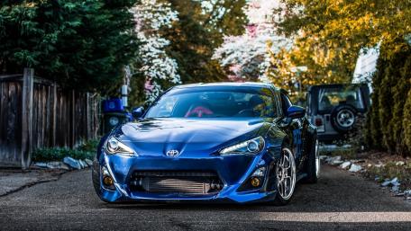 Blue Toyota Sports Car in Scenic Driveway wallpaper