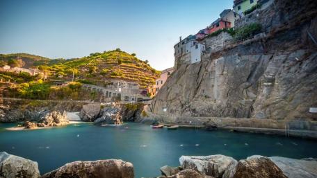 Serene Coastal Village Surrounded by Dramatic Cliffs and Clear Waters wallpaper
