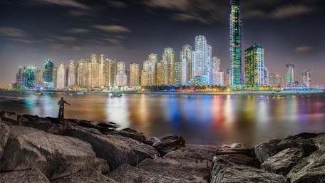Stunning Night Cityscape with Vibrant Lights and Reflections wallpaper