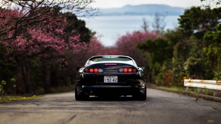 Drive Through Nature's Beauty with a Toyota Supra wallpaper