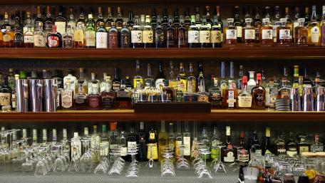 Vibrant Bar Counter filled with Bottles and Glassware wallpaper