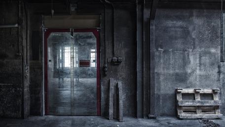 Urban Industrial Scene with Closed Door and Pallet wallpaper