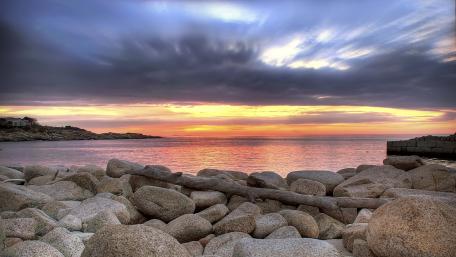 Sunset Serenity by the Rocky Shoreline wallpaper